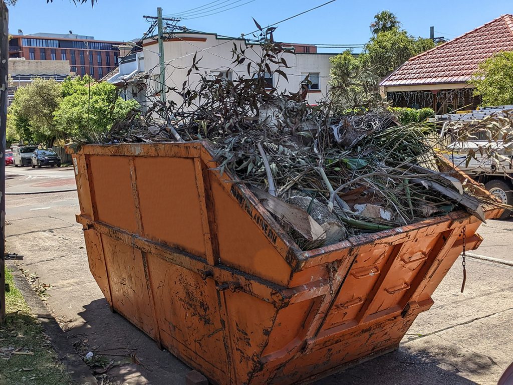 Large orange skip bin hired for green garden waste