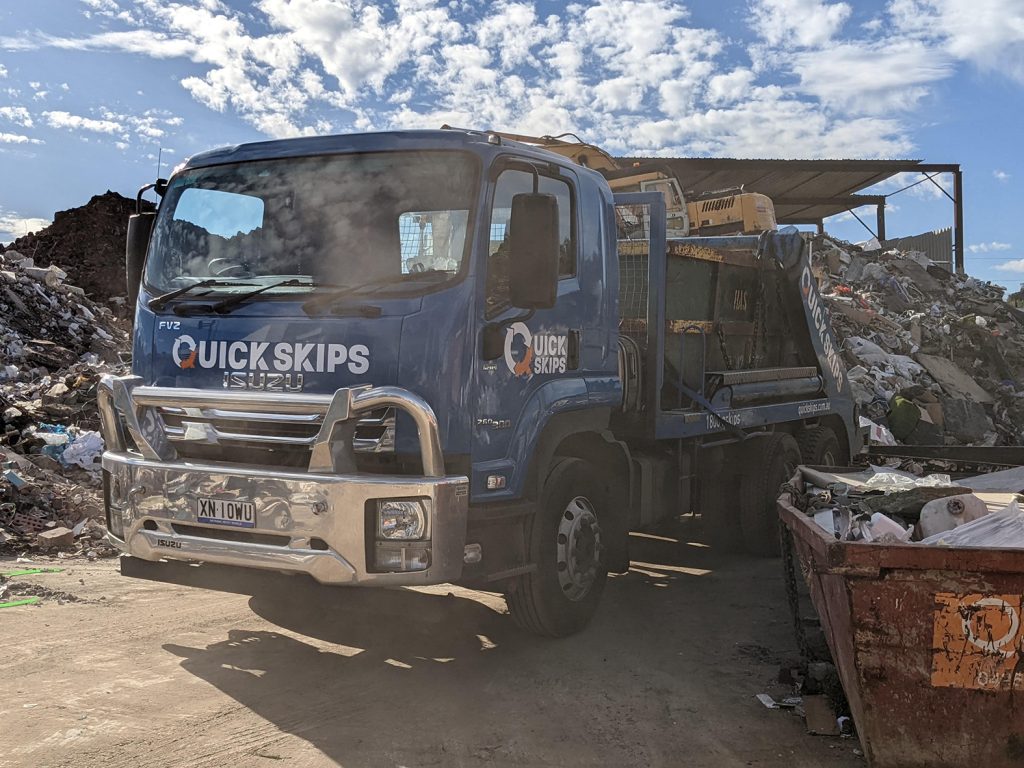 scrap metal skip bin hire truck at depot