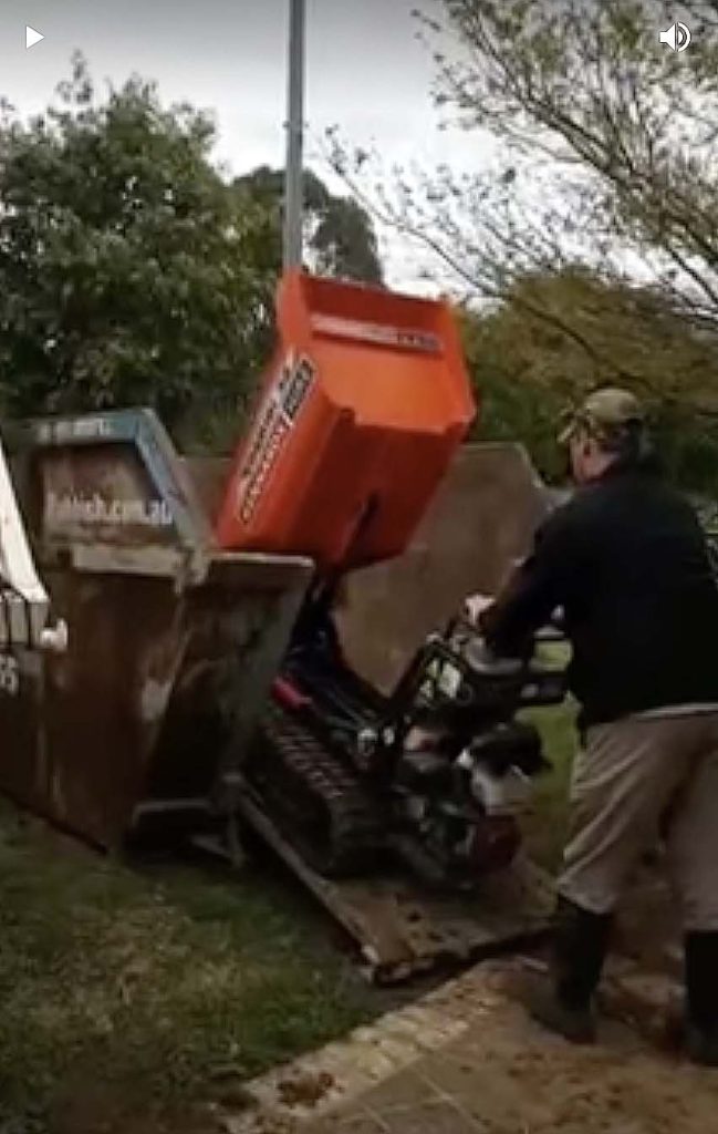 kennard hire dumping machine filling skip bin via rear door